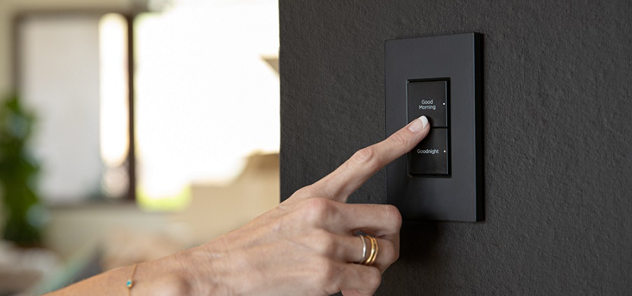 a living room with white sofas, a center table, and a TV