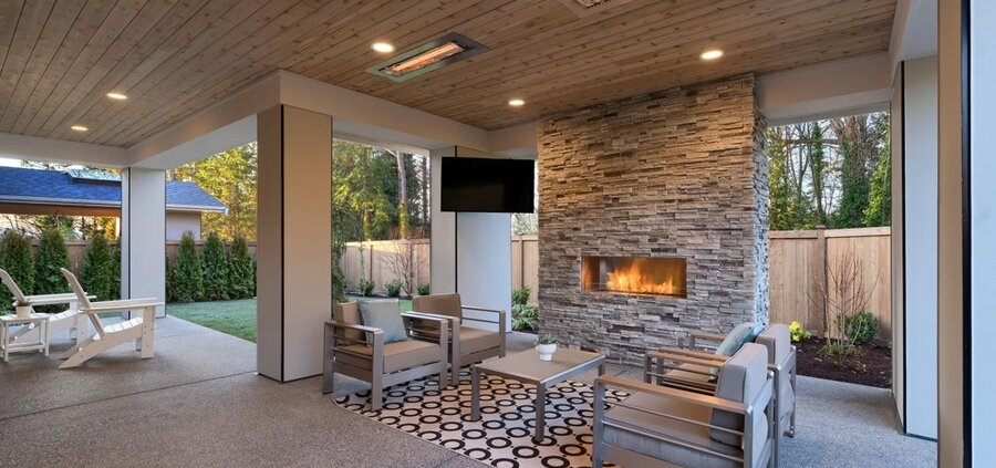 An outdoor patio and backyard featuring an outdoor TV